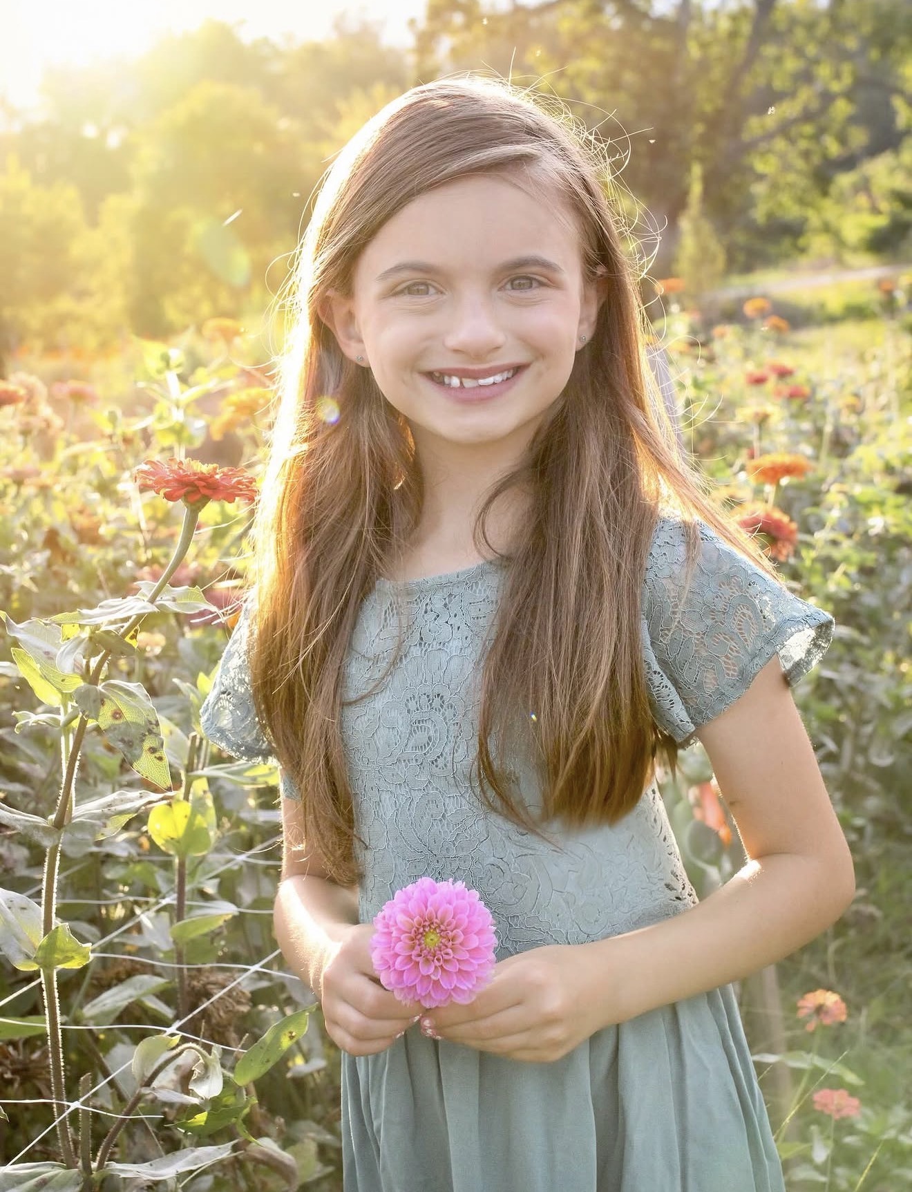 Young girl holding a flower outdoors