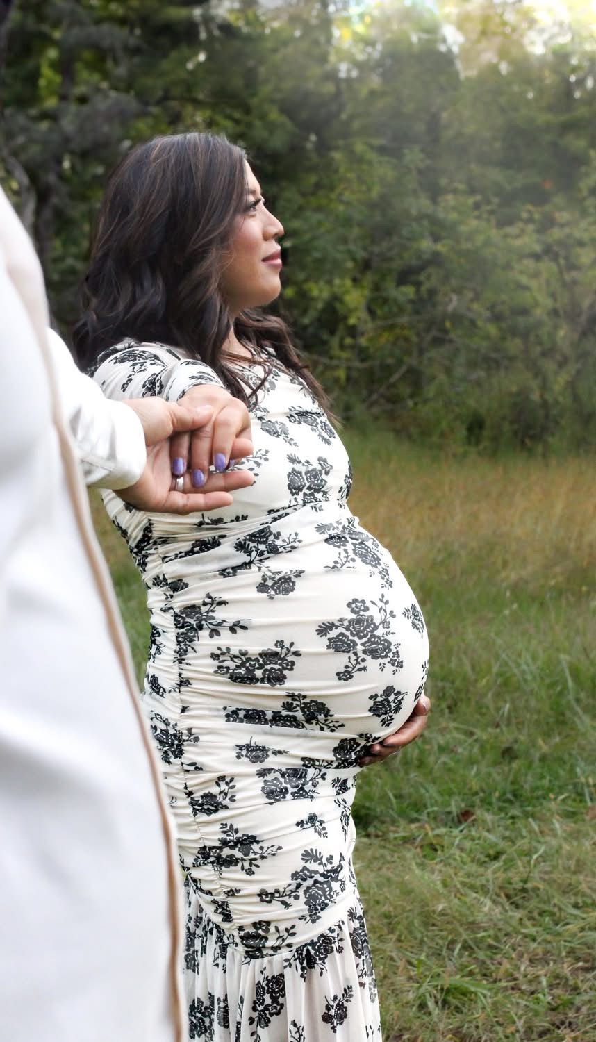 Hands resting on an expectant mother’s belly