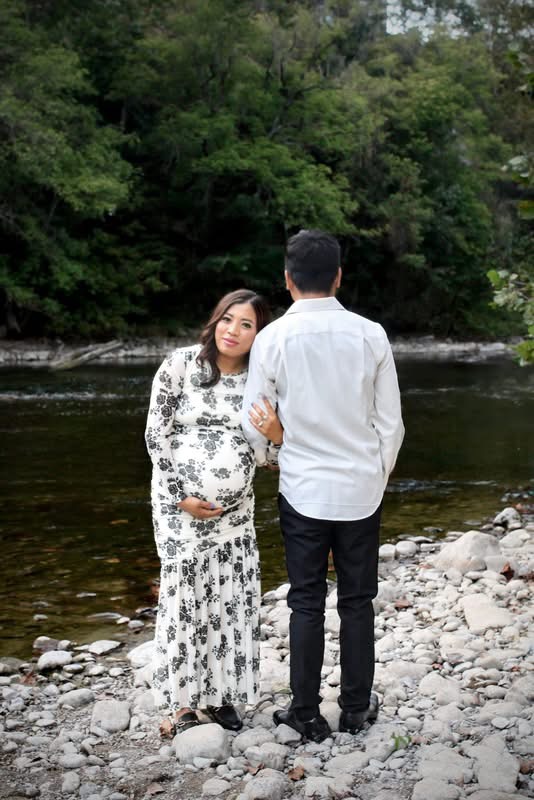 Expecting couple beside the river