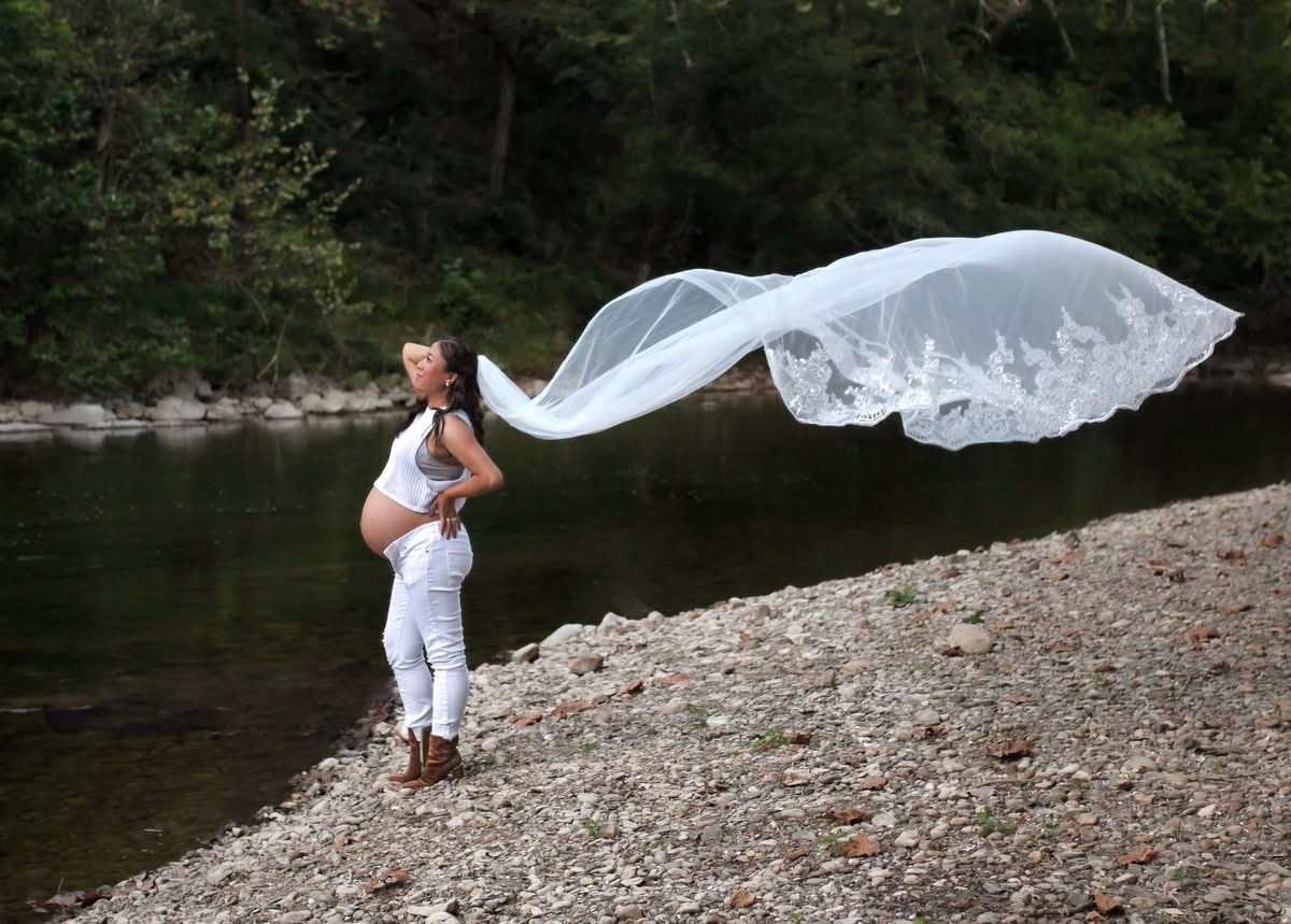 Full-length maternity portrait beside the river by Lauren Kennedy
