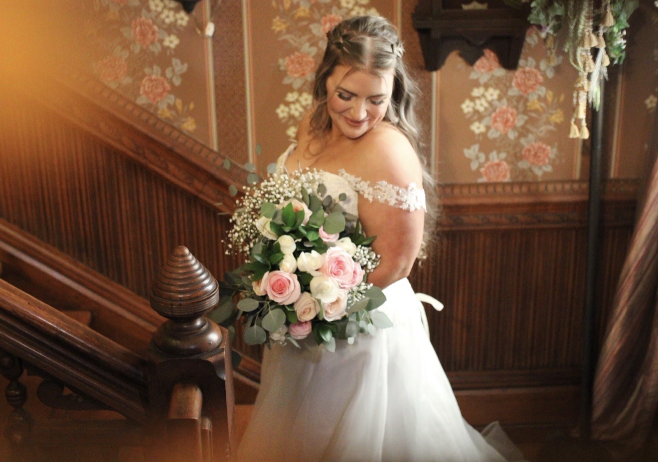 Bride holding her bouquet on a staircase